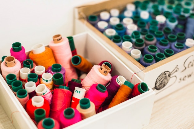 Close-up of many colorful threads in container