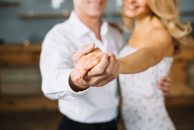 Close-up of married couple dancing