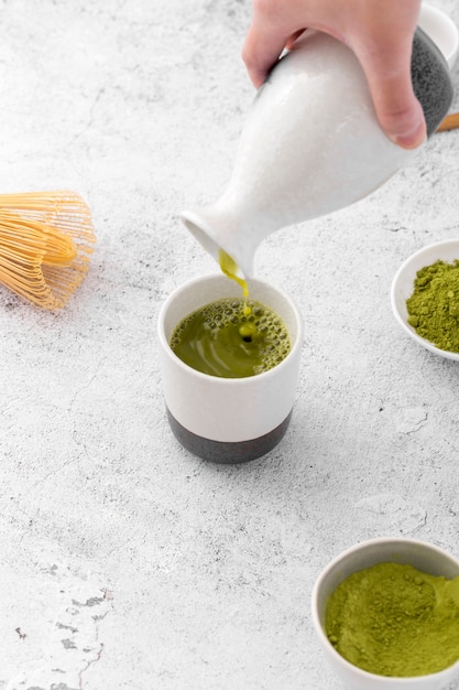 Free Photo close-up matcha tea pouring into cup