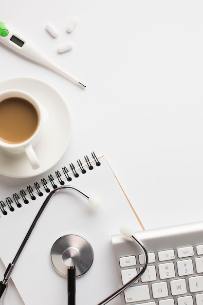 Free Photo close-up of medical healthcare desk with coffee cup on white surface