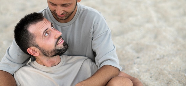 Close-up men holding each other