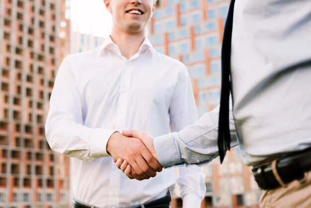 Close-up men shaking hands