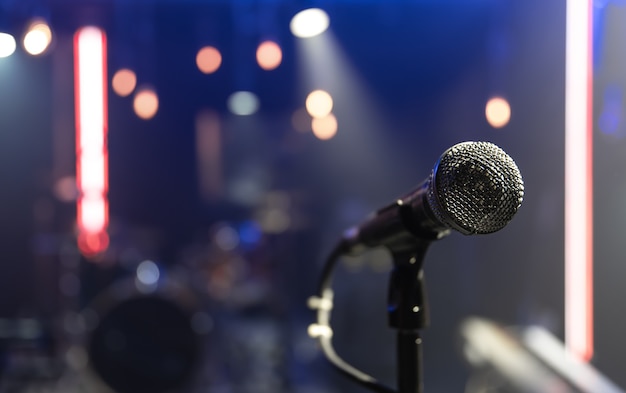 Close up of a microphone on a concert stage with beautiful lighting.