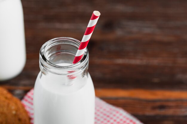 Close up milk bottle with straw