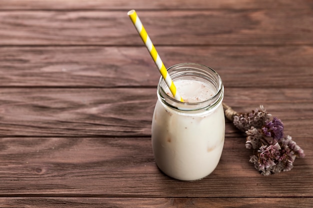 Close up milkshake on wooden table