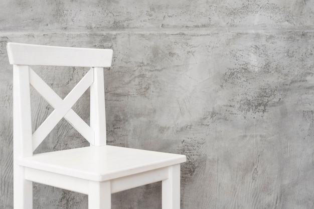 Free Photo close-up minimalist white stool with concrete panels