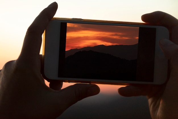 Free Photo close-up mobile phone being held by hands