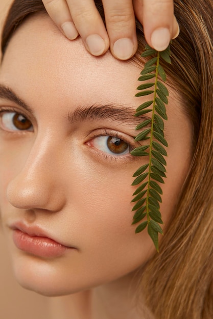 Close up model posing with plant