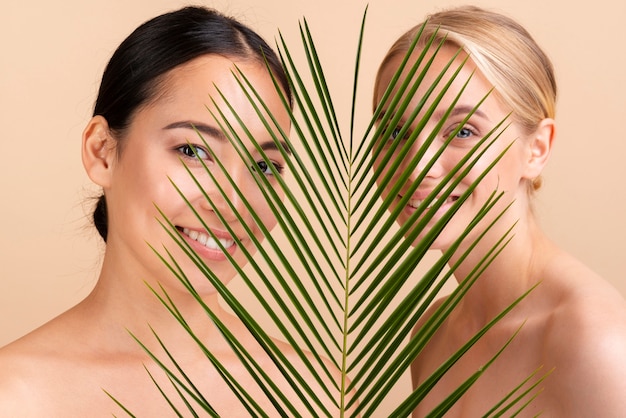 Free Photo close-up models posing together with leaves