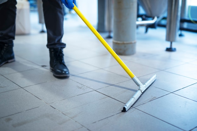 Free Photo close up of mop cleaning industrial plant floor