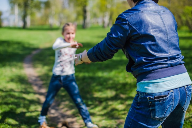 Close-up of mother playing with her daughter in the park