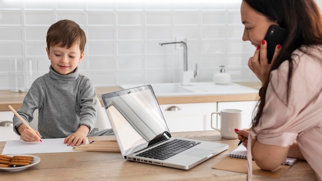 Close up mother working with laptop