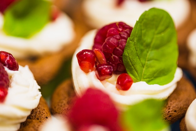 Close-up muffin with raspberry and whipped cream