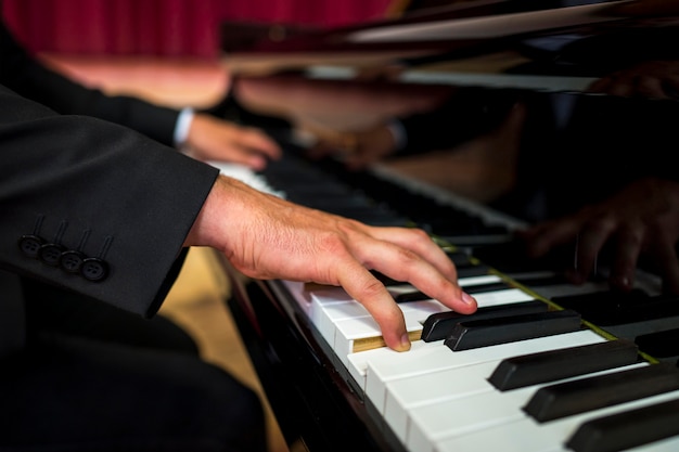 Free photo close-up musician playing piano