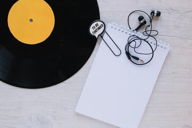 Free photo close-up notebook near vinyl record