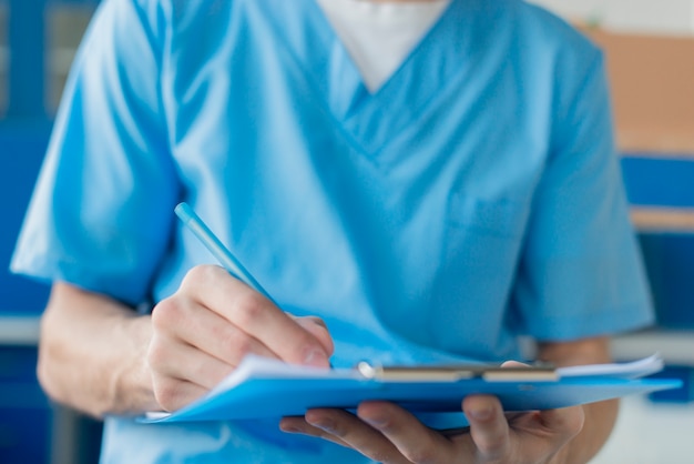 Close-up nurse male with clipboard