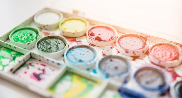 Free photo close-up of a old messy watercolor palette