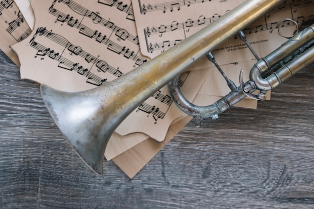 Close-up old trumpet on sheet music