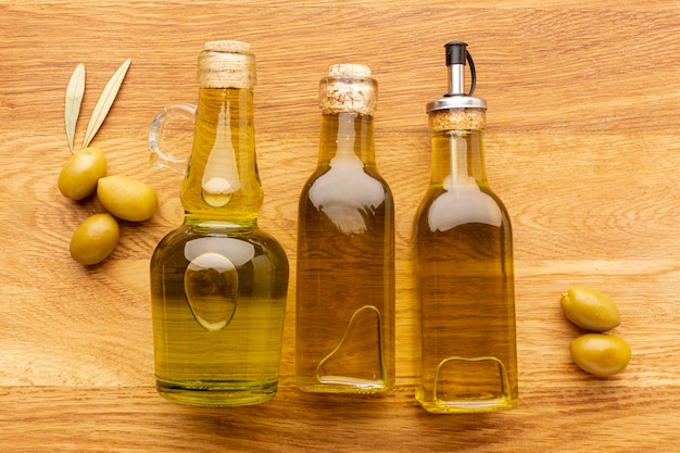 Free photo close up olive bottles yellow olives and leaves