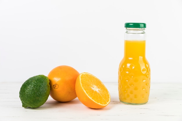 Free photo close up orange juice bottle on table