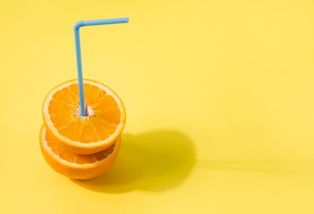 Free photo close-up organic orange slices with straw