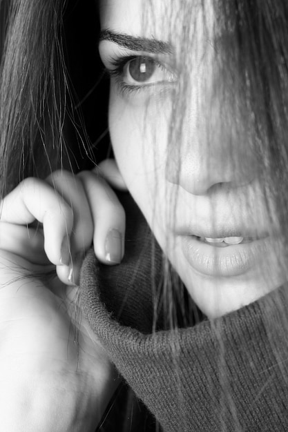 Close-up of pensive woman in black and white