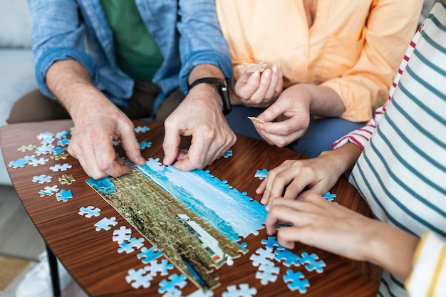 Free photo close up people doing puzzle together