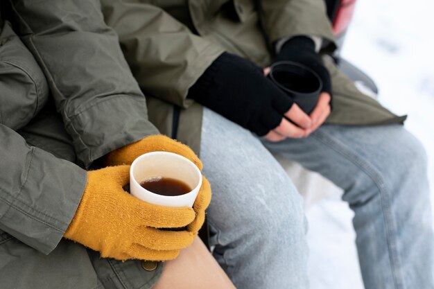 Close up people holding coffee cups