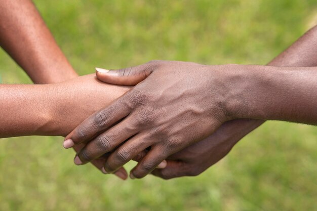 Close up people holding hands