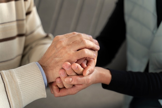 Free photo close up people holding hands