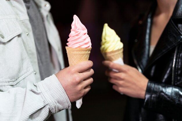 Close up people holding ice cream