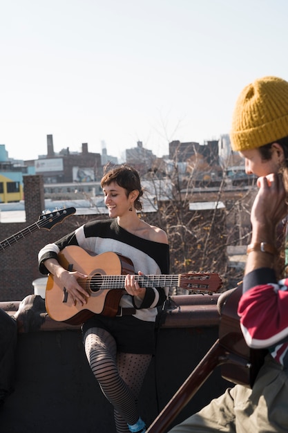 Free Photo close up people making music on rooftop