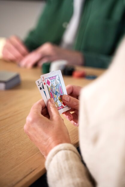 Close up people playing cards