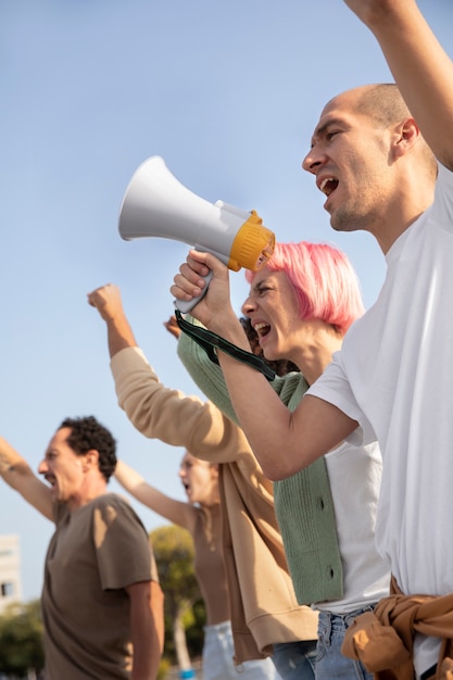 Free photo close up people protesting with megaphones