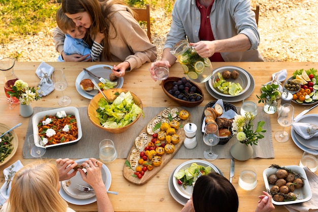 Close up people at table with tasty food