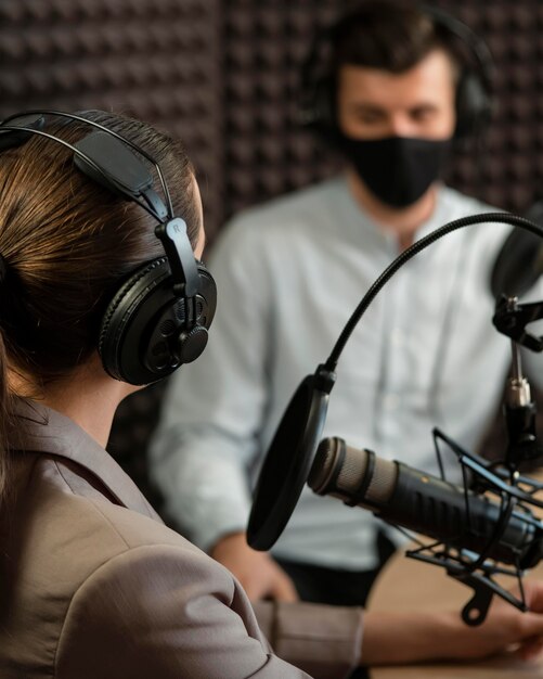 Close-up people wearing mask at radio