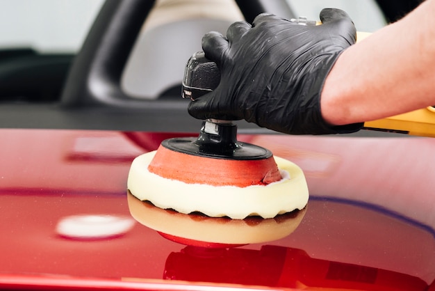 Free Photo close up of person cleaning car exterior