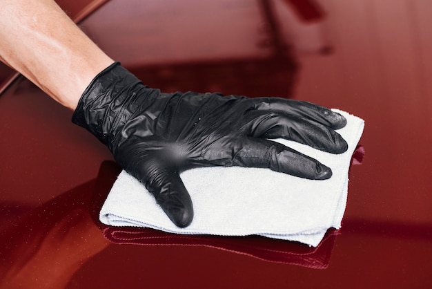 Free Photo close up of person cleaning car exterior