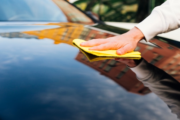 Close up of person cleaning car exterior