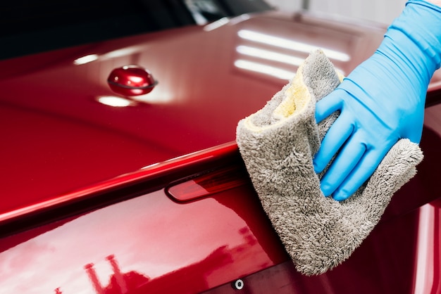 Free Photo close up of person cleaning car exterior