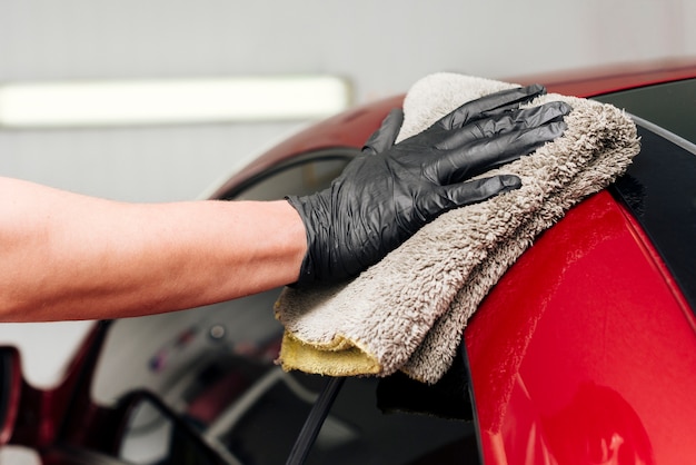 Close up of person cleaning car exterior