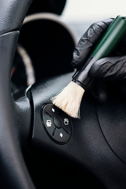 Close up of person cleaning car interior