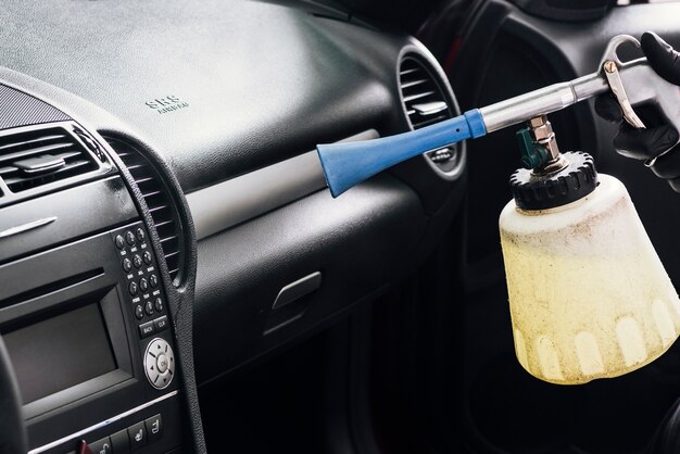 Close up of person cleaning car interior