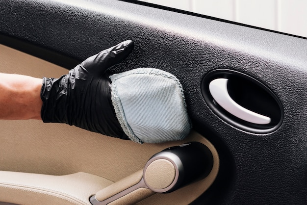 Close up of person cleaning car interior