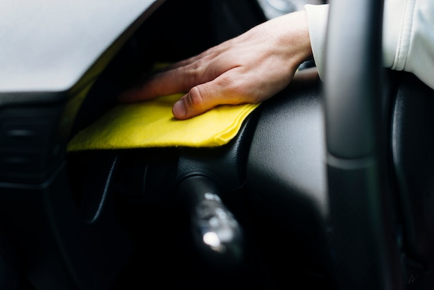 Close up of person cleaning car interior