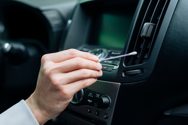 Free Photo close up of person cleaning car interior