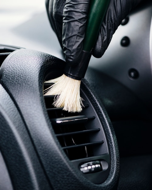 Close up of person cleaning car interior