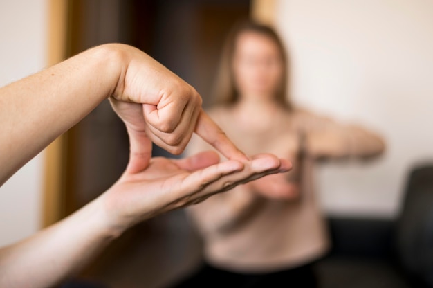 Free Photo close-up person communicating through sign language