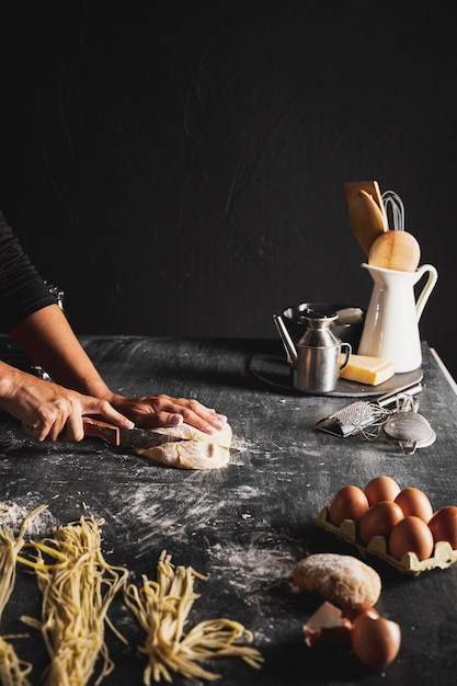 Free photo close-up person cutting dough with utensils