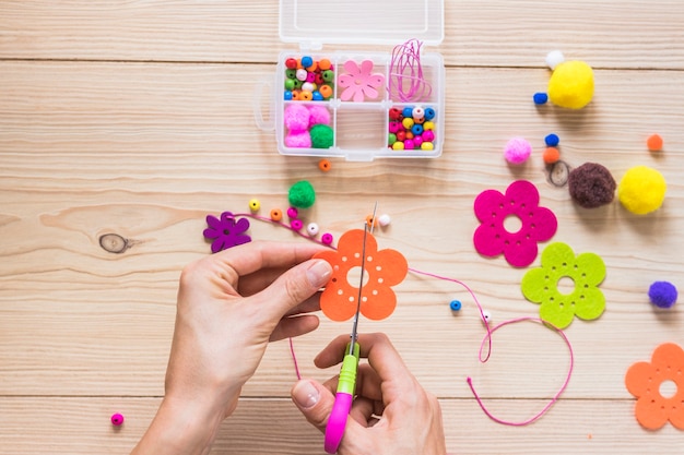 Free photo close-up of a person cutting flower patch with scissor